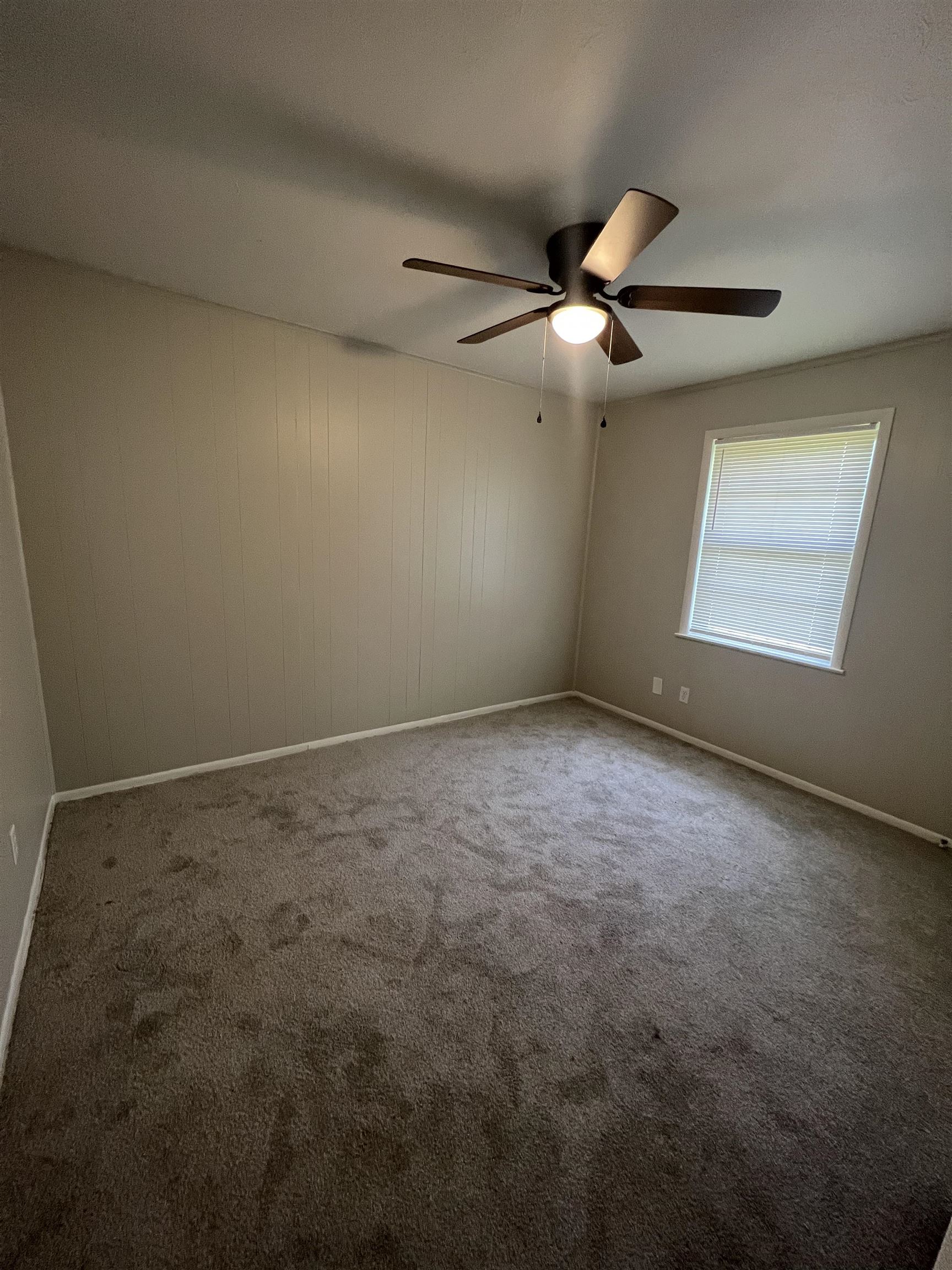 4224 Arrow Road Memphis, TN 38109 - Photo 7 of 11 an empty room with windows and fan