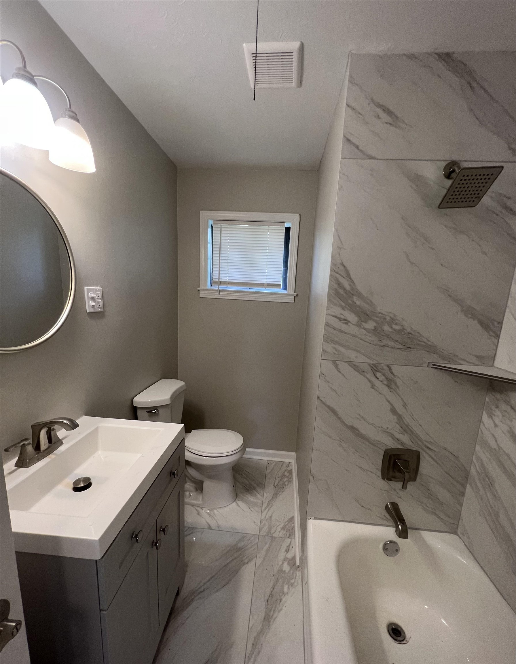 4224 Arrow Road Memphis, TN 38109 - Photo 9 of 11 a bathroom with a sink a toilet and a mirror
