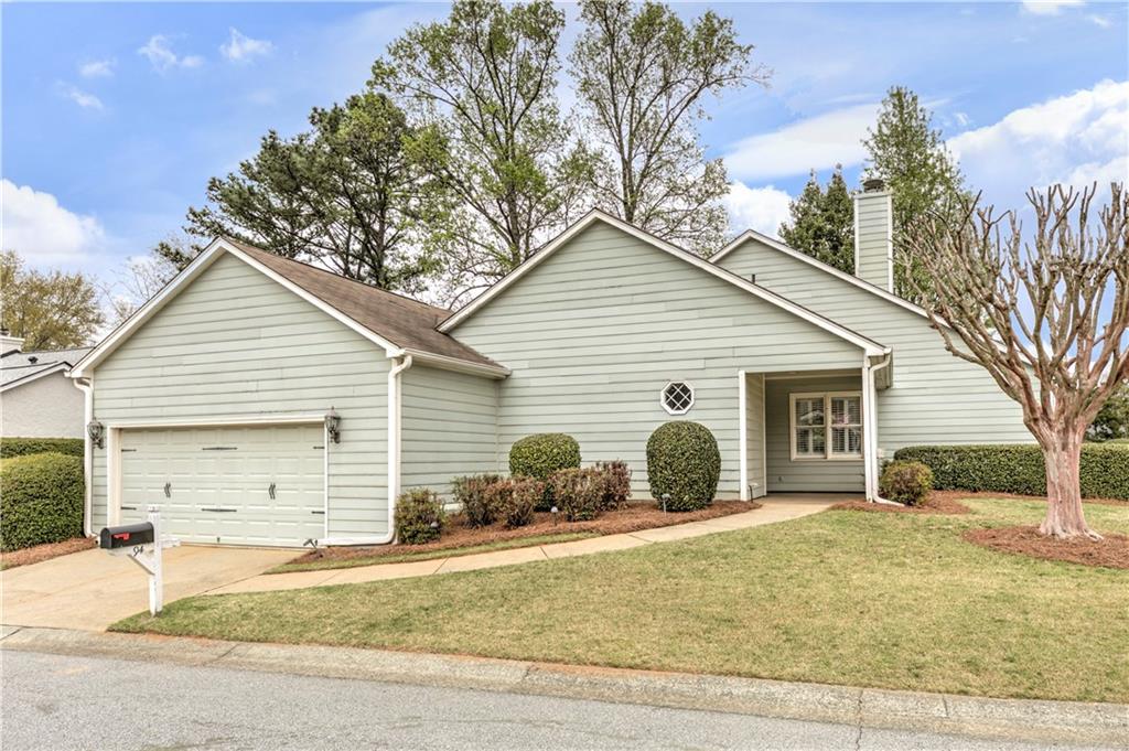 94 Robyn Way Marietta, GA 30062 - Photo 4 of 40 a view of a house with a yard and large tree