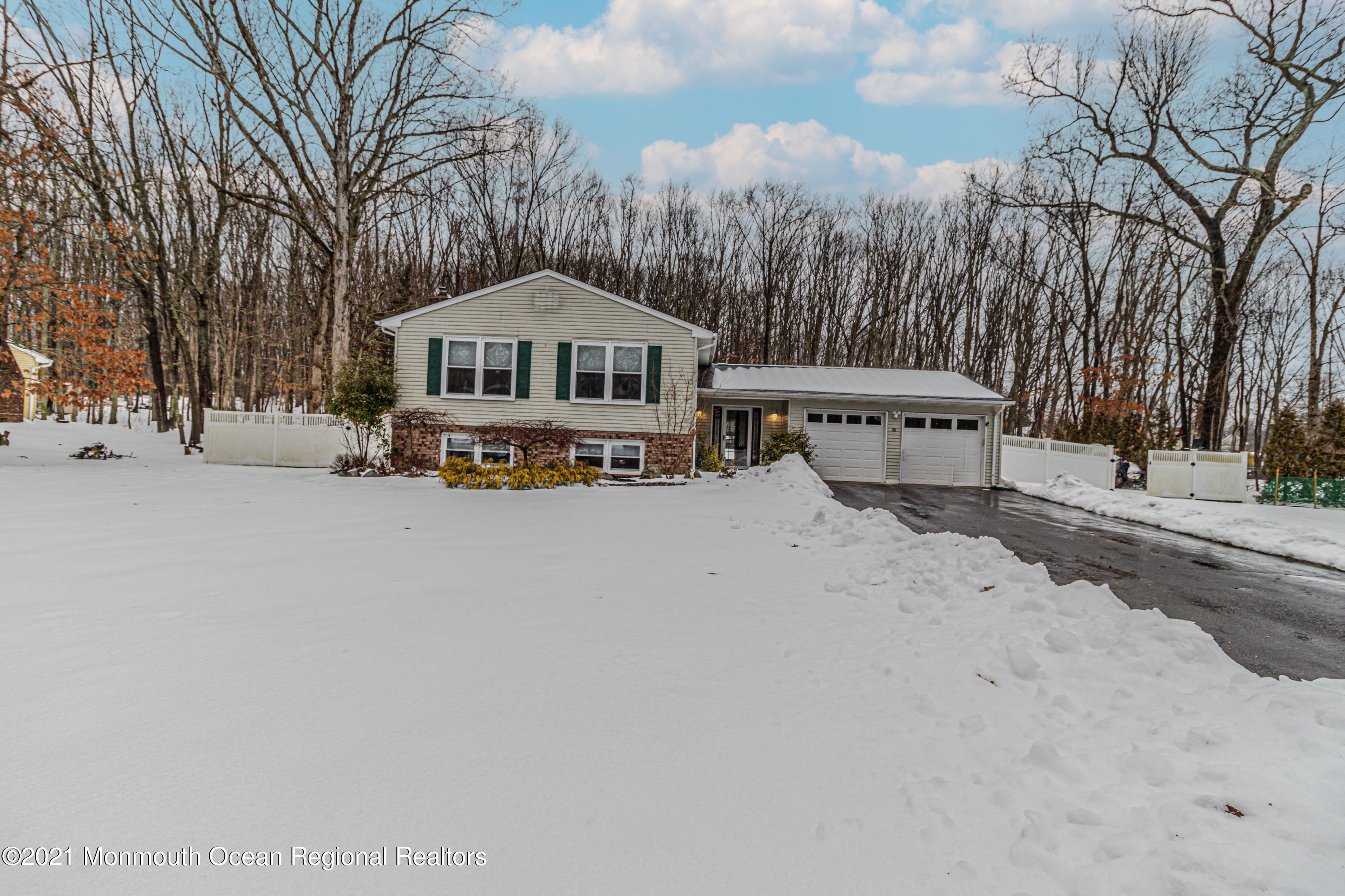a view of a house with a yard covered in snow