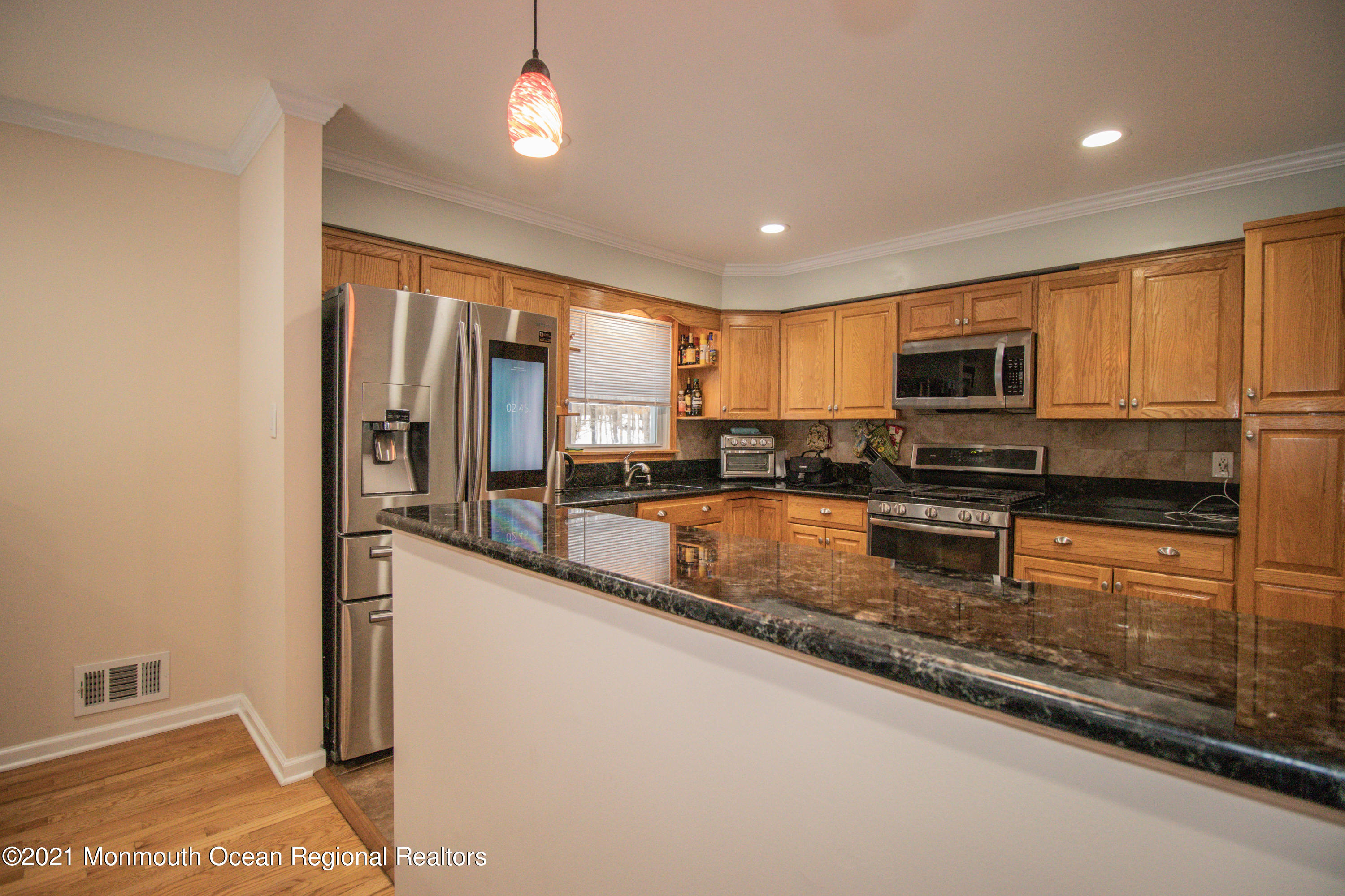 30 Eaglenest Road Freehold, NJ 07728 - Photo 13 of 39 a kitchen with stainless steel appliances granite countertop a stove a sink and a refrigerator