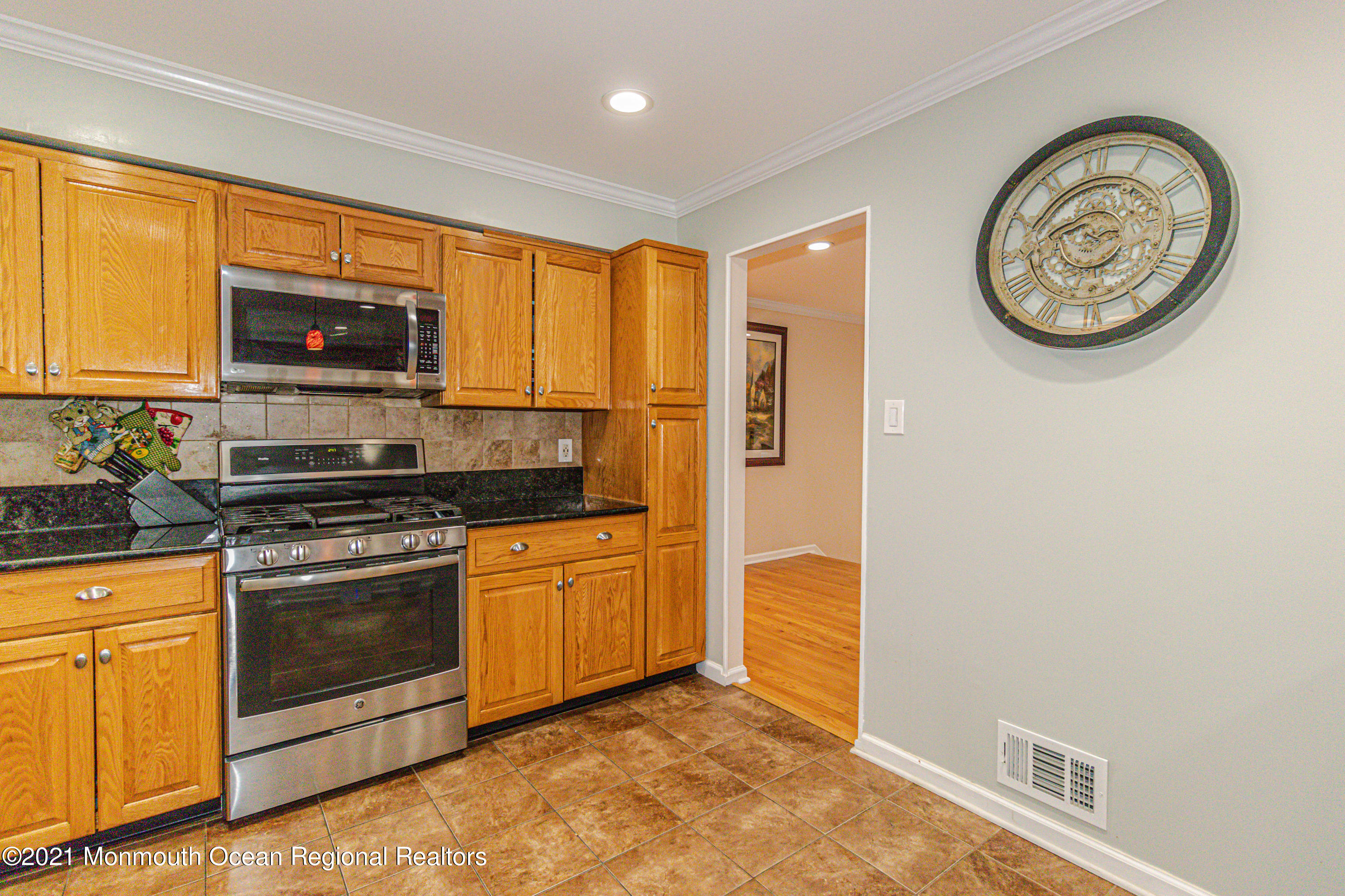 30 Eaglenest Road Freehold, NJ 07728 - Photo 16 of 39 a kitchen with stainless steel appliances granite countertop a stove a microwave and a refrigerator