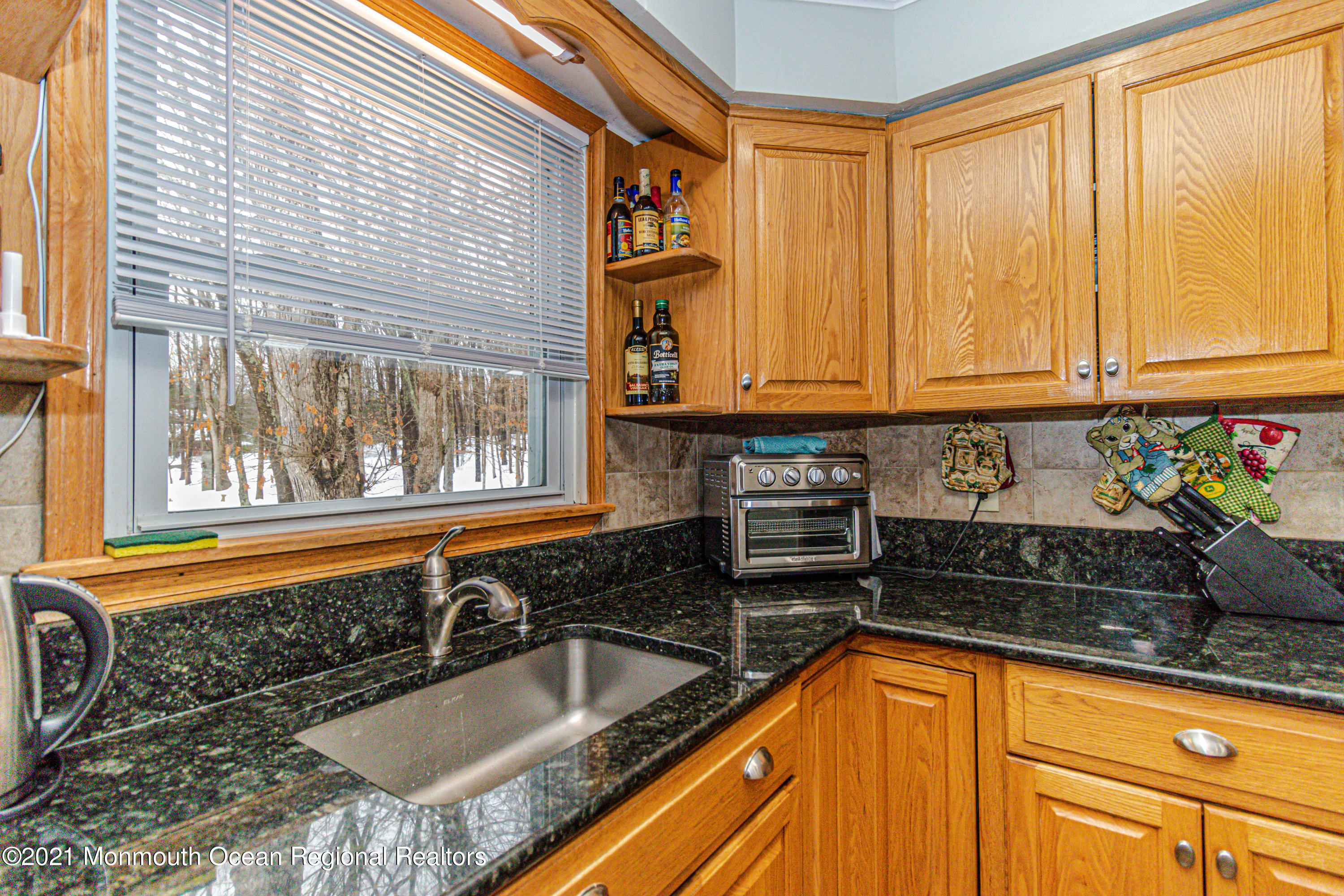 30 Eaglenest Road Freehold, NJ 07728 - Photo 17 of 39 a kitchen with granite countertop a sink and a window