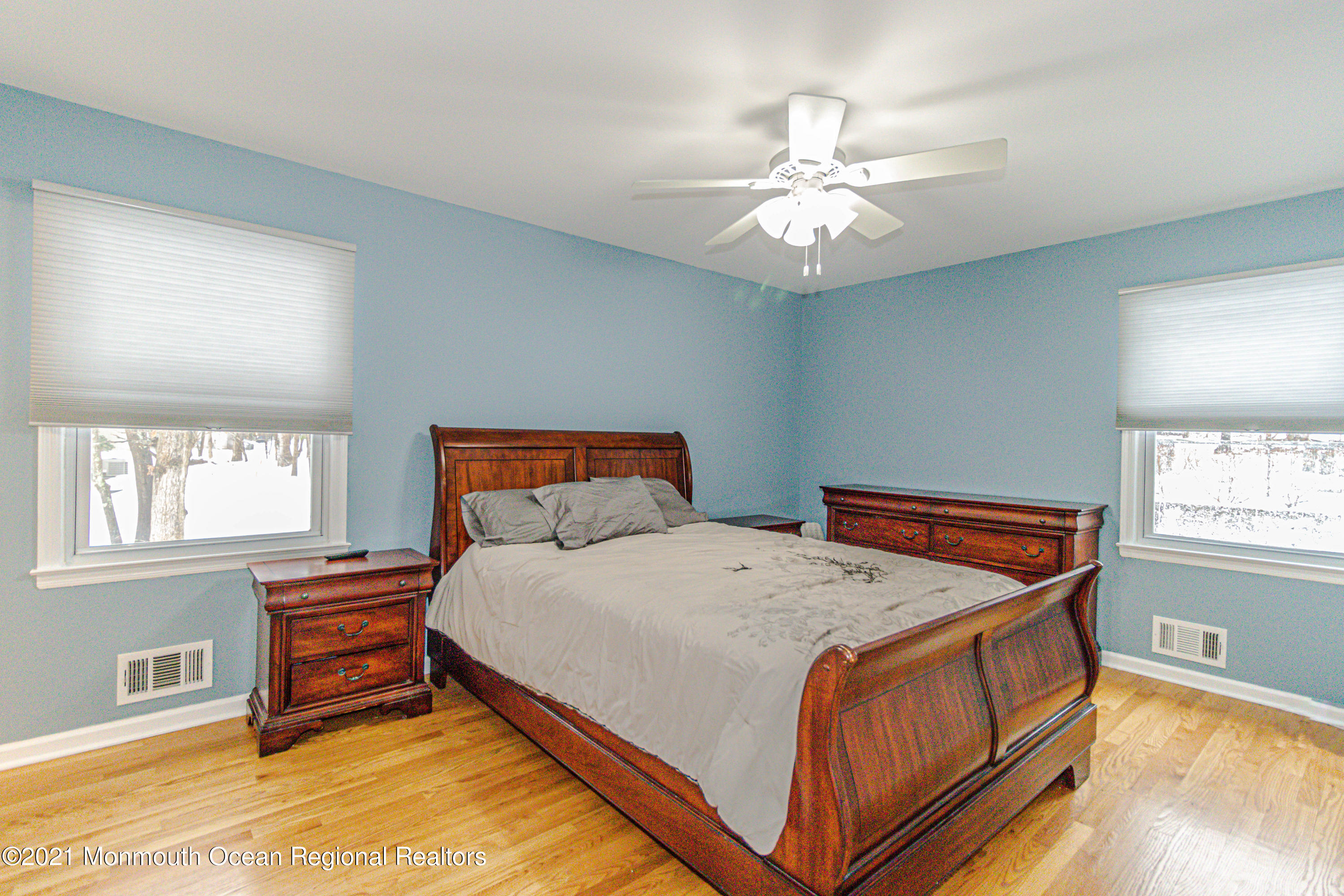 30 Eaglenest Road Freehold, NJ 07728 - Photo 19 of 39 a bedroom with a bed and a chandelier