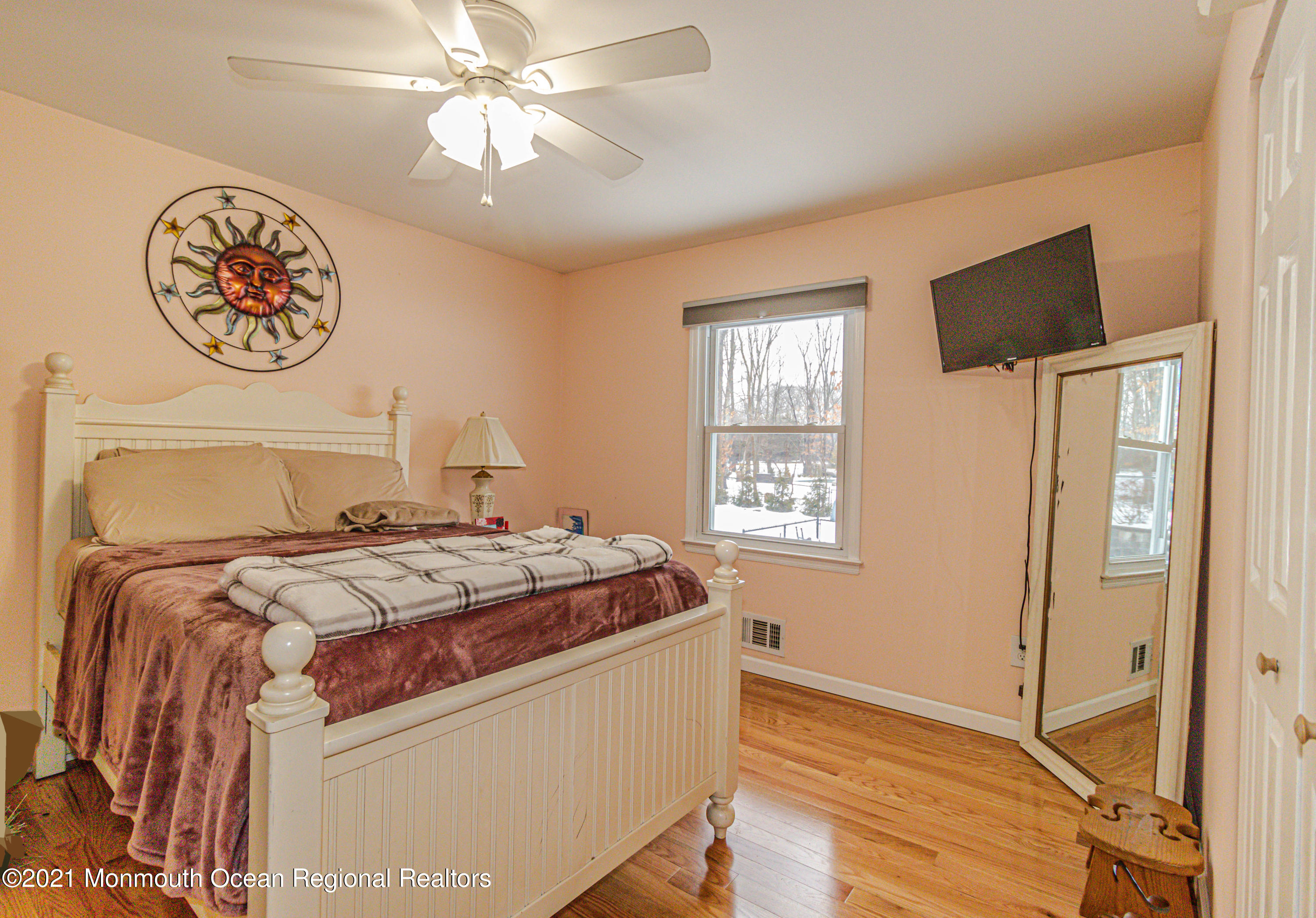 30 Eaglenest Road Freehold, NJ 07728 - Photo 24 of 39 a bedroom with a bed and a chandelier