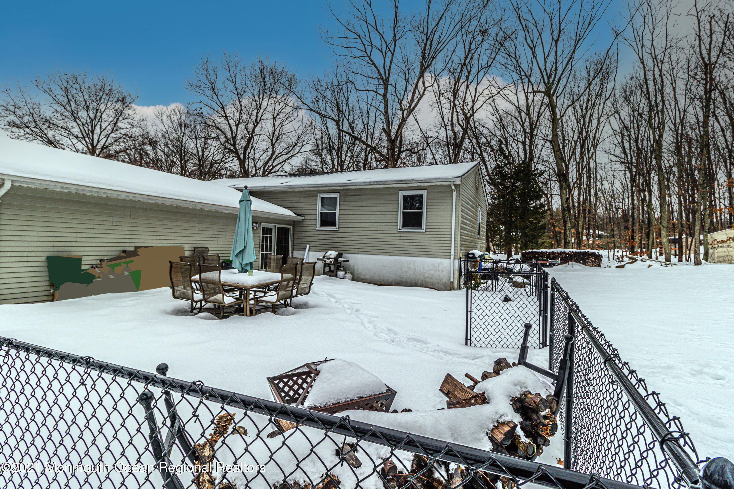 30 Eaglenest Road Freehold, NJ 07728 - Photo 37 of 39 a view of a patio with dining table and chairs with wooden fence and plants