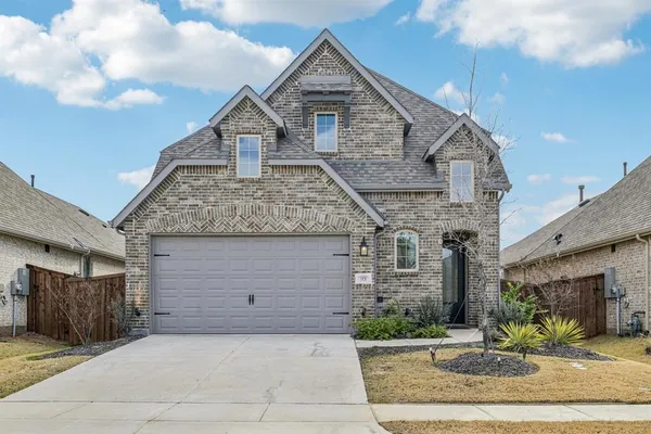 a front view of a house with garage