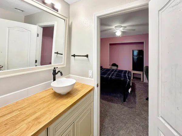 a bed room with a bed mirror and a window