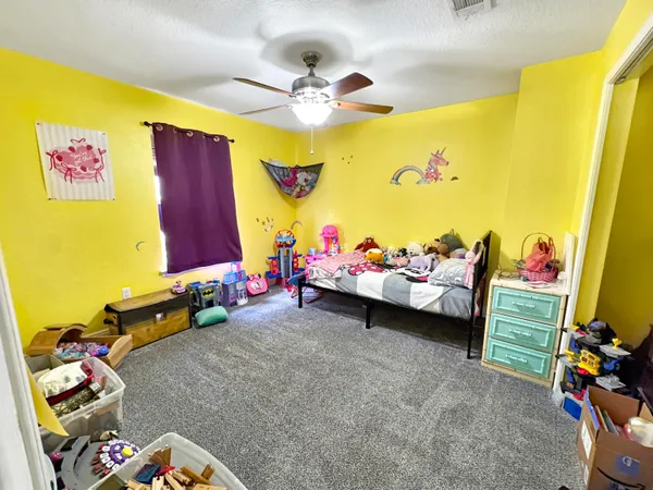 a bedroom with a bed and a desk