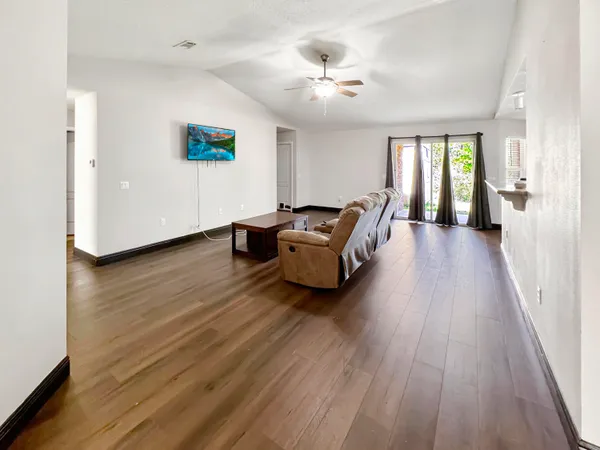 a living room with furniture and wooden floor
