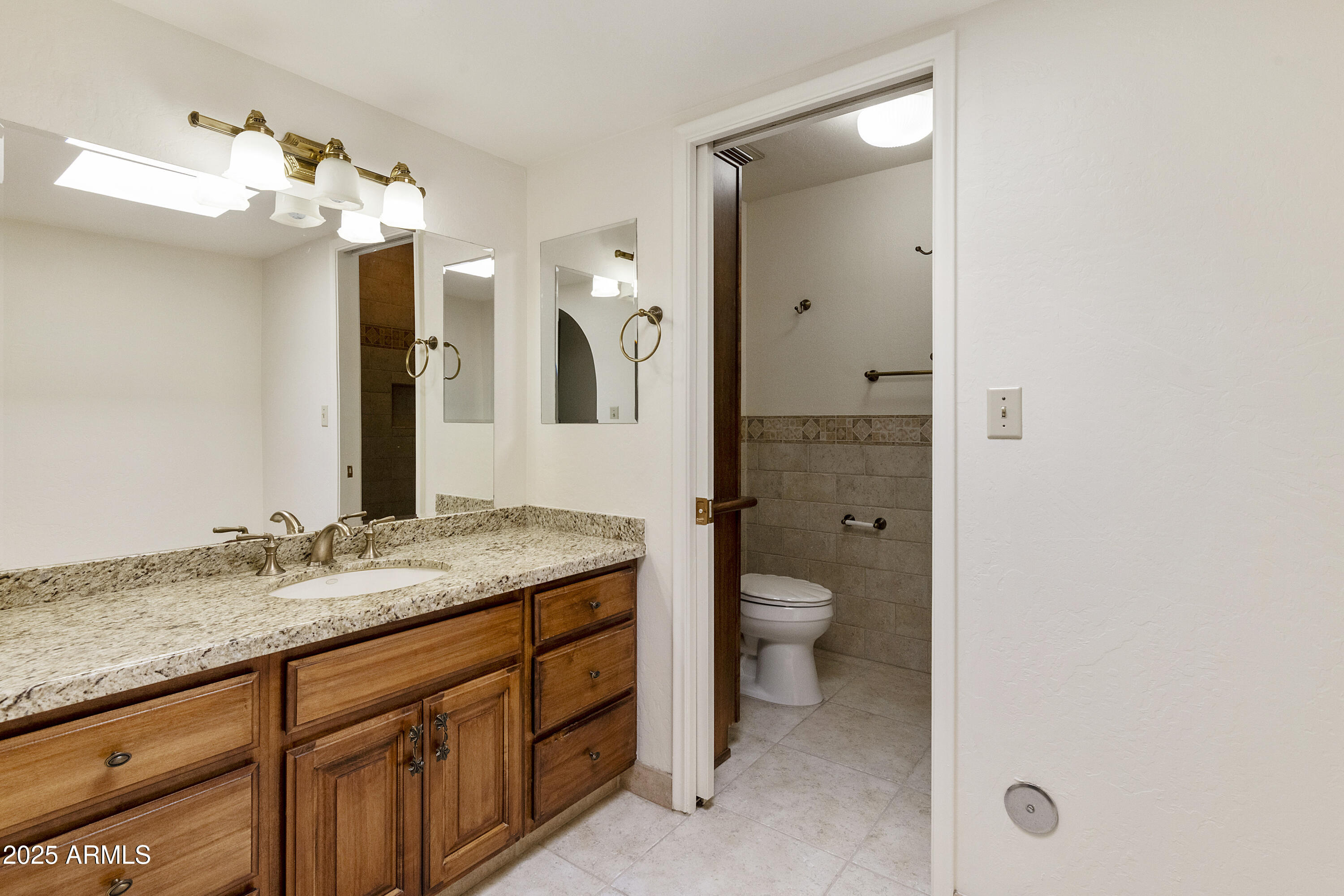5622 North Palacio Way Phoenix, AZ 85014 - Photo 14 of 26 a bathroom with a granite countertop sink mirror and toilet