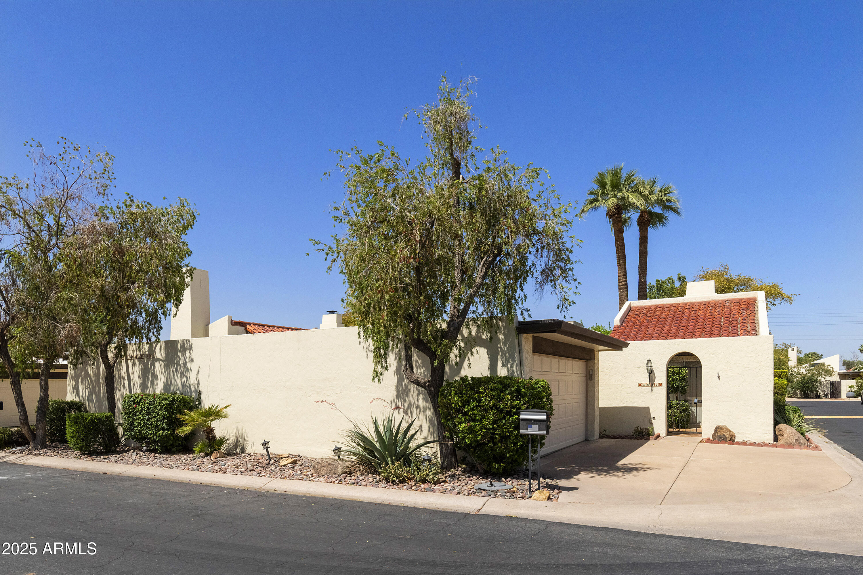 5622 North Palacio Way Phoenix, AZ 85014 - Photo 25 of 26 a front view of a house with a yard and garage