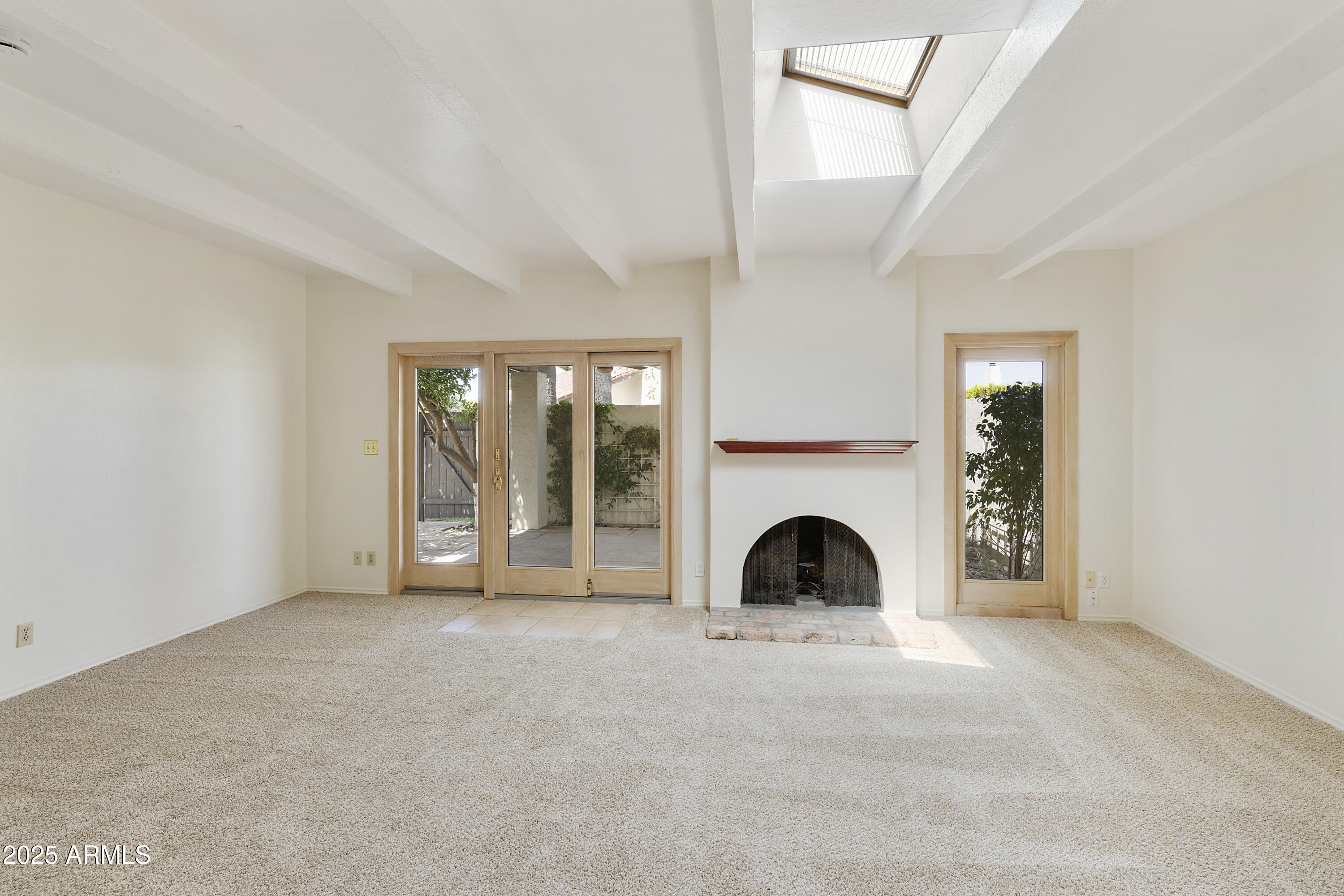 5622 North Palacio Way Phoenix, AZ 85014 - Photo 6 of 26 a view of an empty room with fireplace and windows