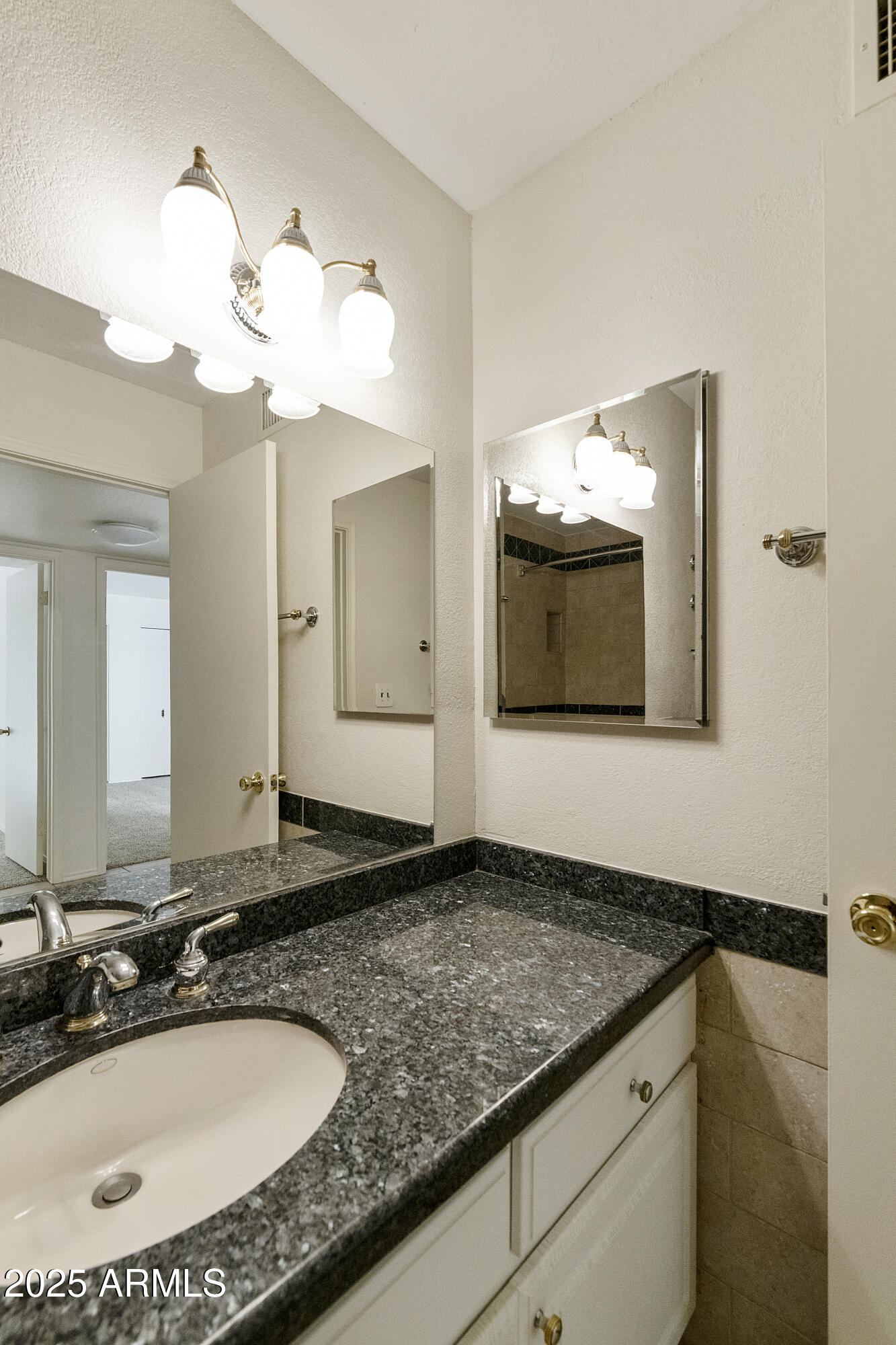 5622 North Palacio Way Phoenix, AZ 85014 - Photo 10 of 26 a bathroom with a granite countertop sink and a mirror