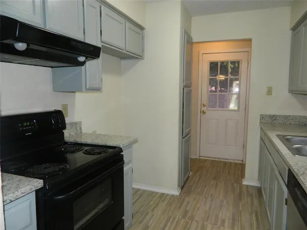 a kitchen with stainless steel appliances granite countertop a stove and a refrigerator