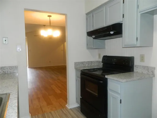 a kitchen with a stove and a microwave