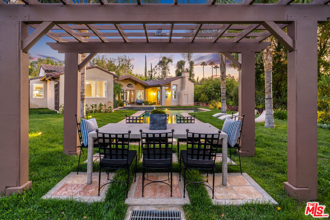 19261 Wells Drive Tarzana, CA 91356 - Photo 12 of 51 a view of a patio with table and chairs potted plants with wooden floor