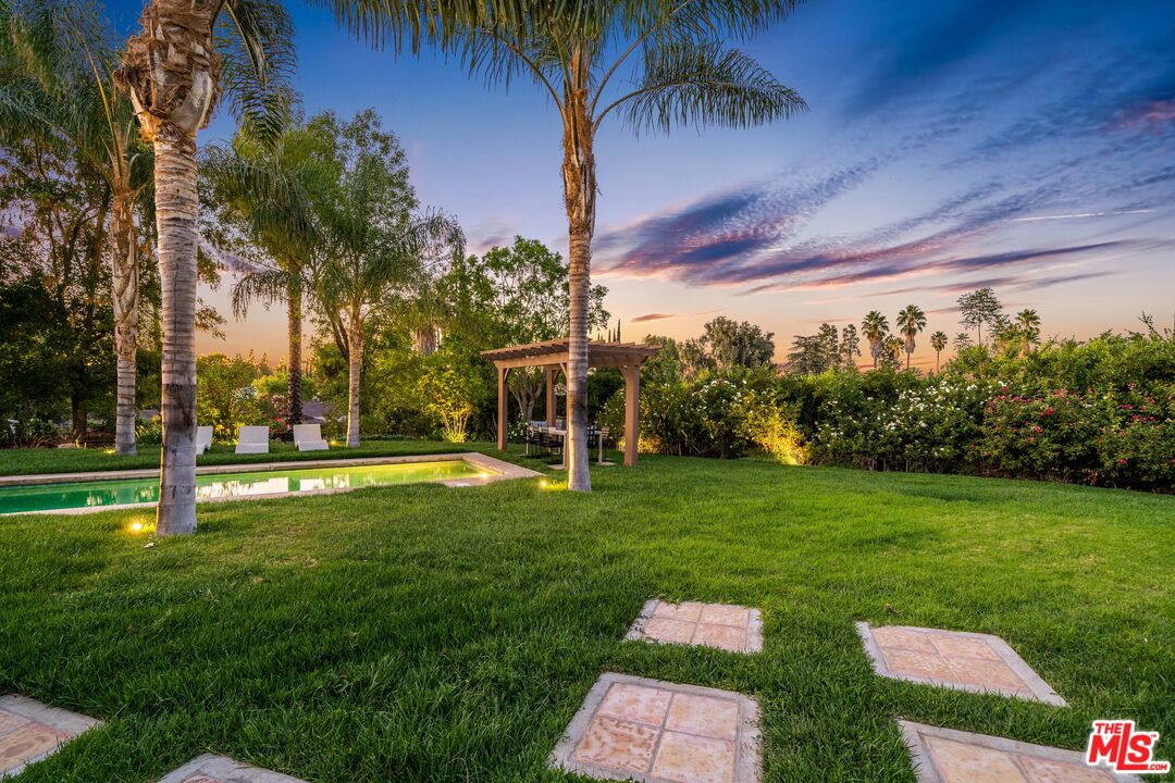 19261 Wells Drive Tarzana, CA 91356 - Photo 14 of 51 a backyard of a house with table and chairs
