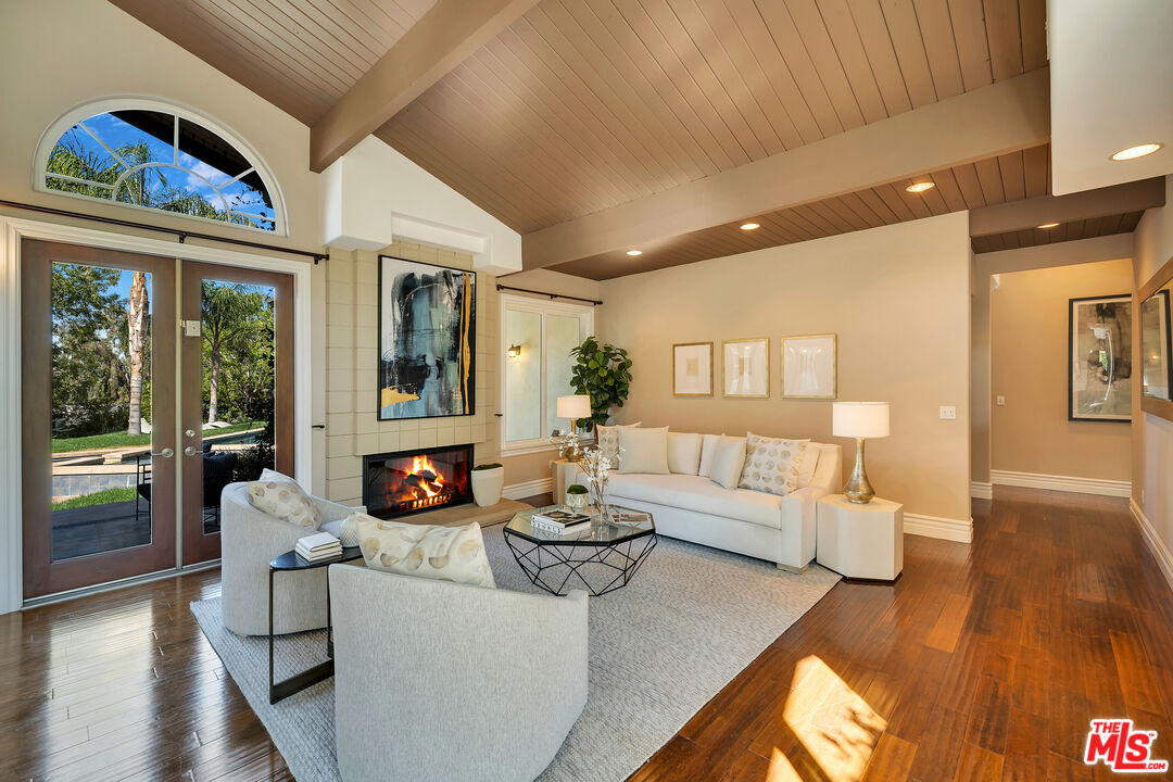 19261 Wells Drive Tarzana, CA 91356 - Photo 19 of 51 a living room with fireplace furniture and a wooden floor