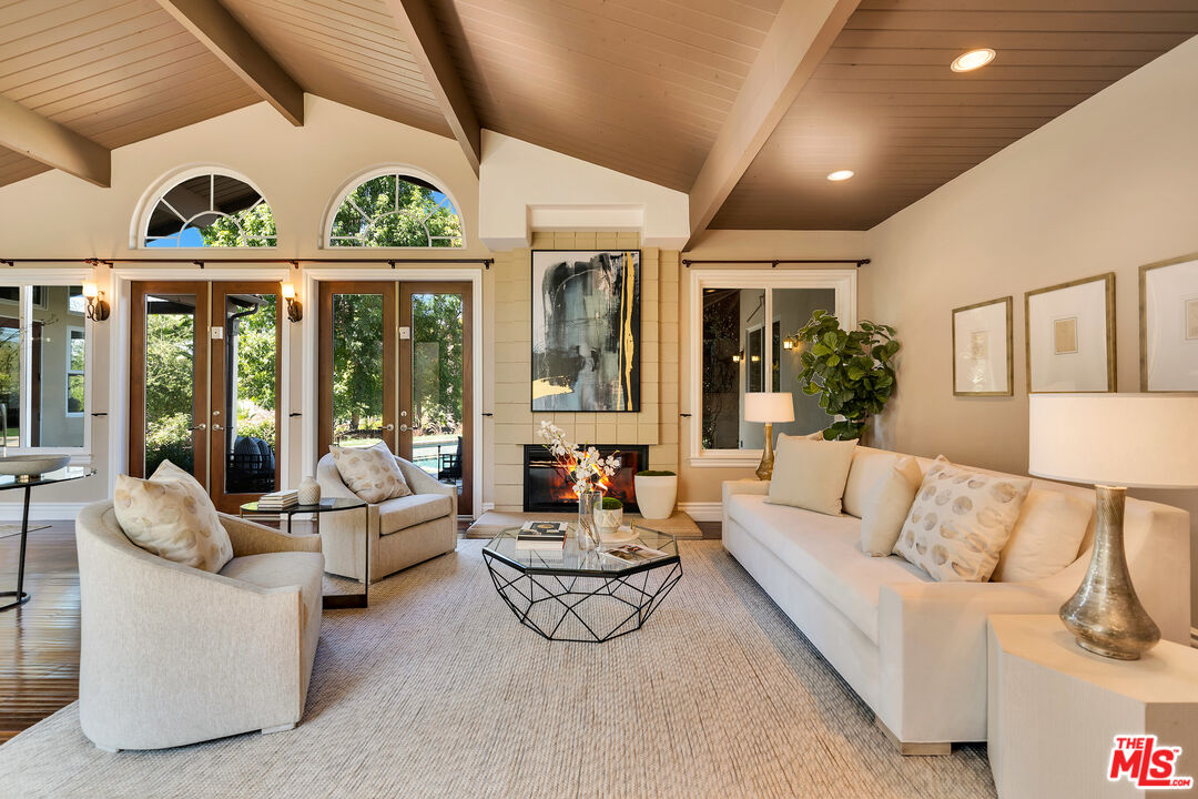 19261 Wells Drive Tarzana, CA 91356 - Photo 20 of 51 a living room with furniture fireplace and large windows