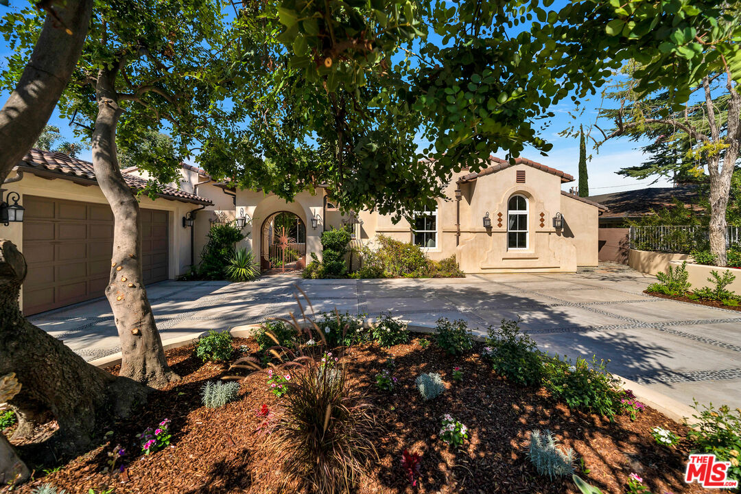 19261 Wells Drive Tarzana, CA 91356 - Photo 2 of 51 a front view of a house with a yard