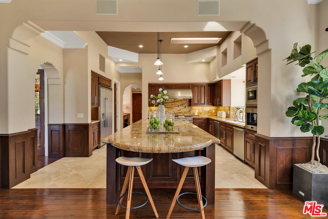 19261 Wells Drive Tarzana, CA 91356 - Photo 32 of 51 a view of a dining room with furniture and wooden floor
