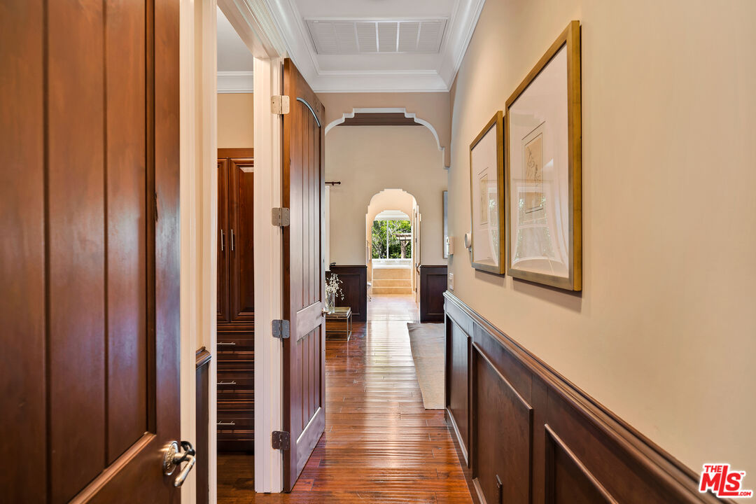 19261 Wells Drive Tarzana, CA 91356 - Photo 35 of 51 a view of a hallway with wooden floor and staircase