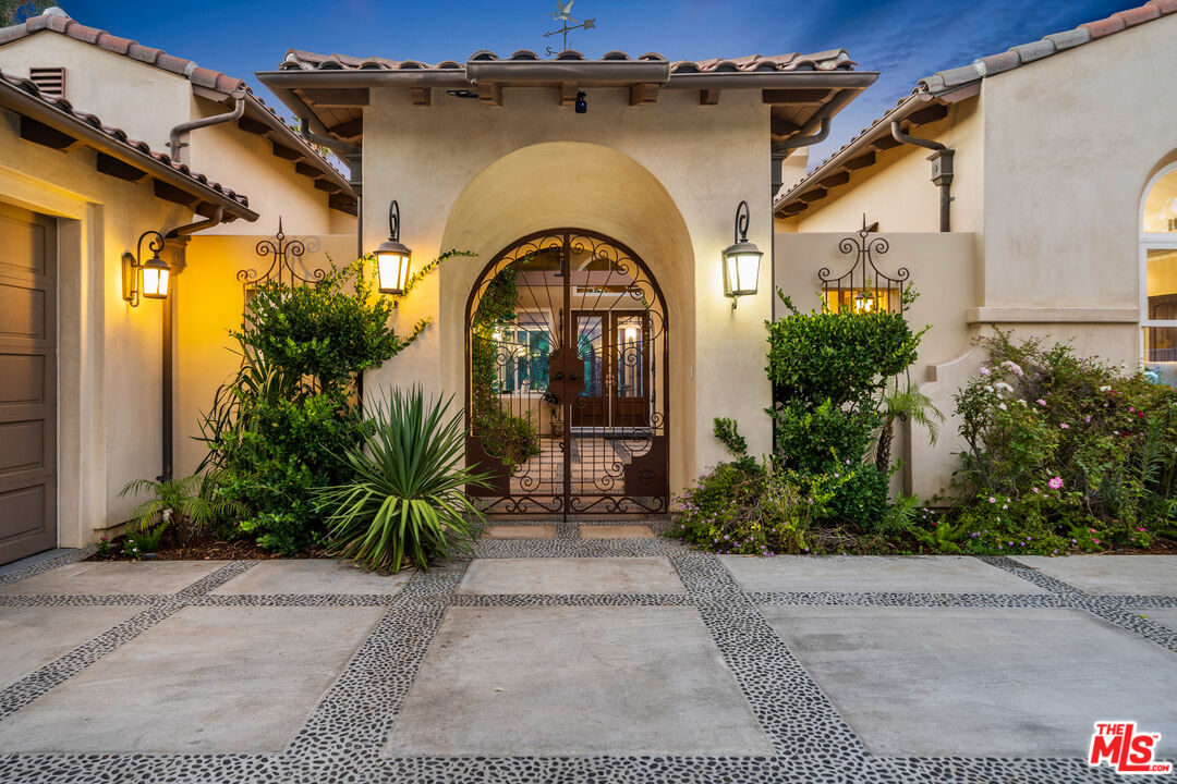 19261 Wells Drive Tarzana, CA 91356 - Photo 4 of 51 a front view of a house with garden