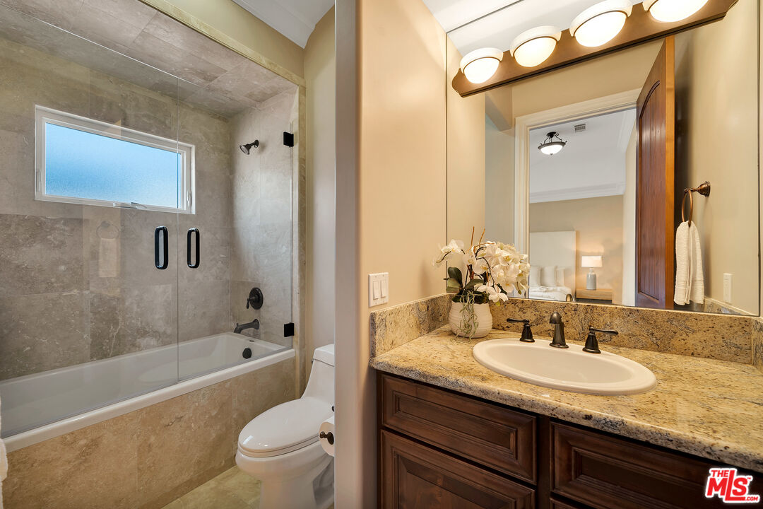 19261 Wells Drive Tarzana, CA 91356 - Photo 43 of 51 a bathroom with a granite countertop sink toilet and shower
