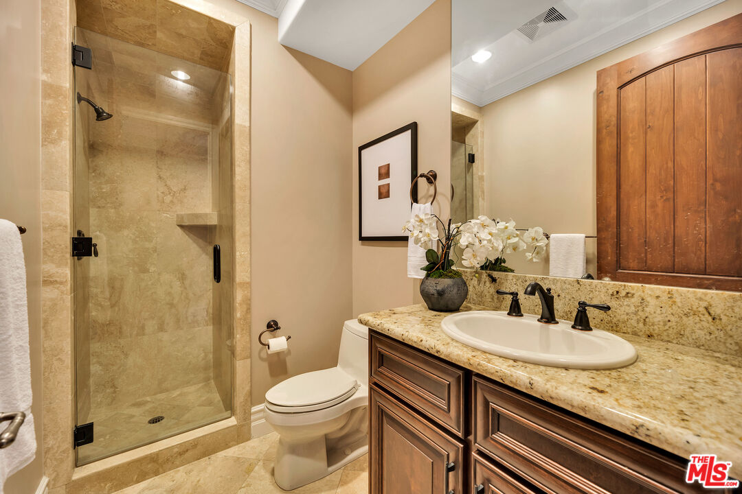 19261 Wells Drive Tarzana, CA 91356 - Photo 45 of 51 a bathroom with a granite countertop sink toilet and shower