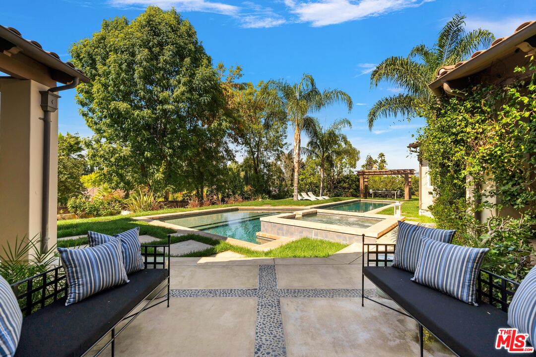19261 Wells Drive Tarzana, CA 91356 - Photo 48 of 51 a view of a swimming pool with a patio and a yard