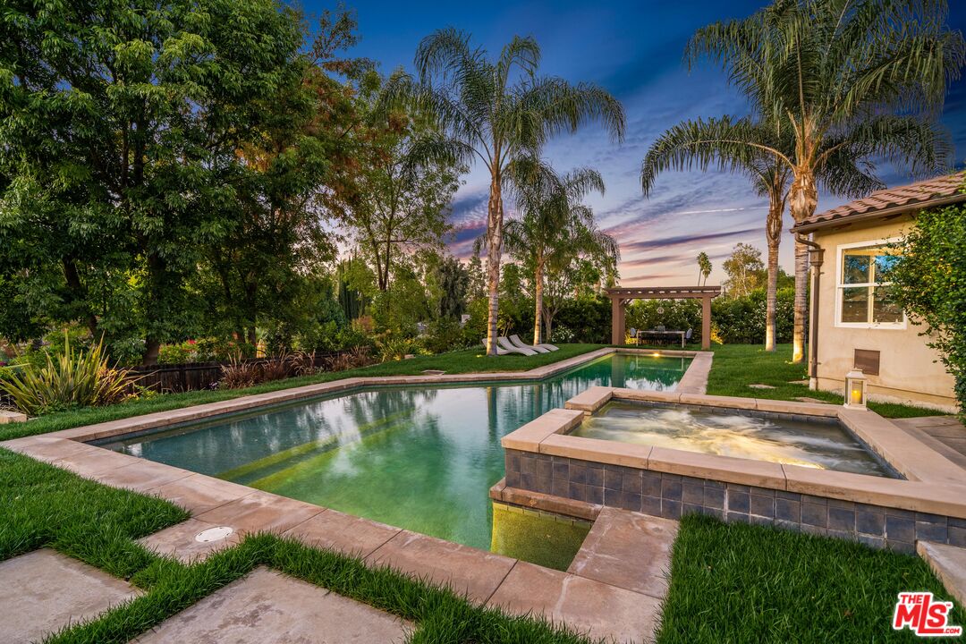 19261 Wells Drive Tarzana, CA 91356 - Photo 8 of 51 a view of a swimming pool with a patio