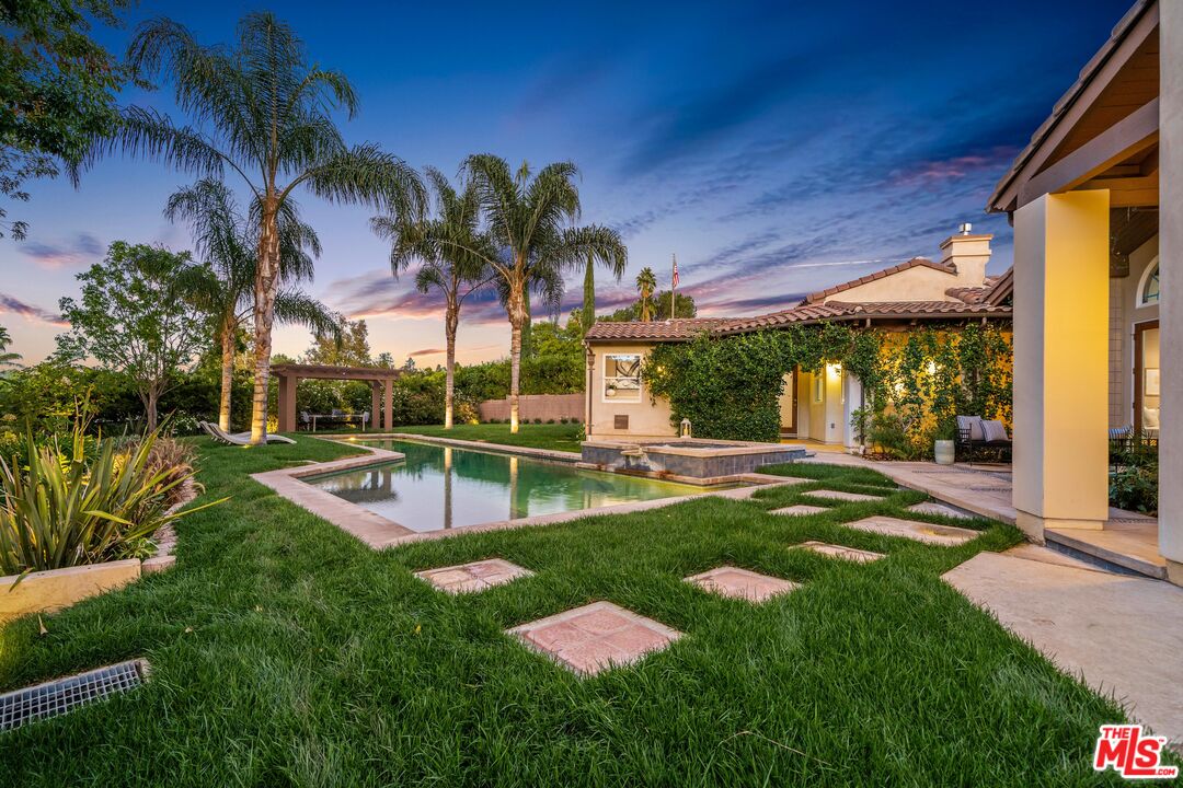 19261 Wells Drive Tarzana, CA 91356 - Photo 9 of 51 a view of a backyard with potted plants and palm trees