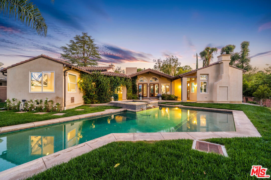 19261 Wells Drive Tarzana, CA 91356 - Photo 10 of 51 a view of a house with swimming pool and a yard