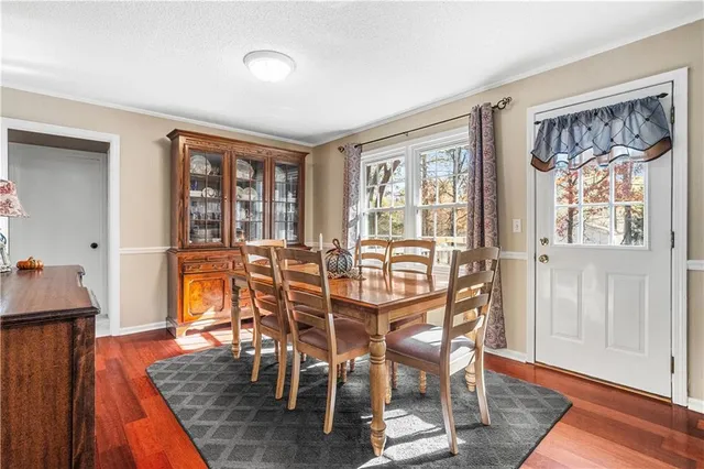 a dining room with furniture and wooden floor