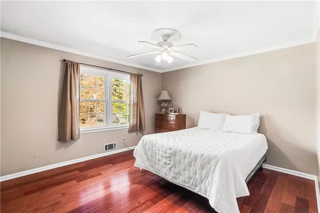 a bedroom with a large bed and a window