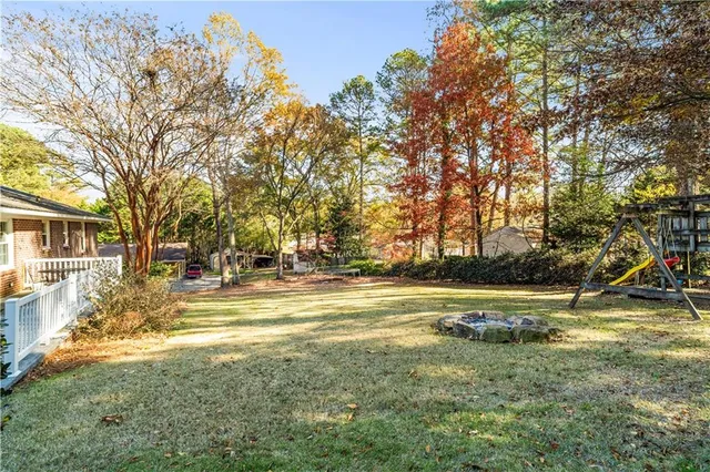 a view of yard with swimming pool and trees
