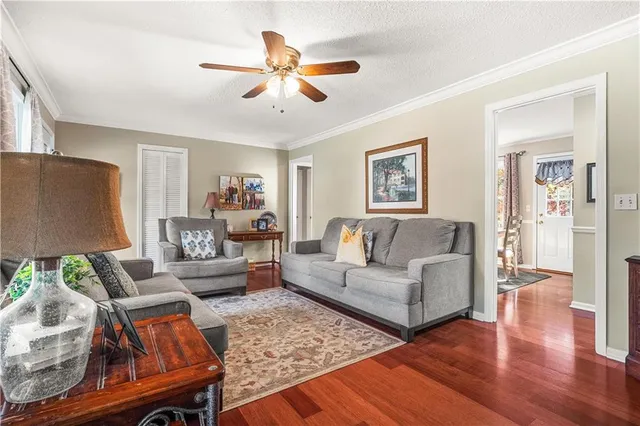 a living room with furniture and a wooden floor