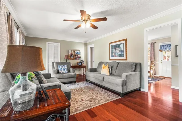a living room with furniture and a wooden floor