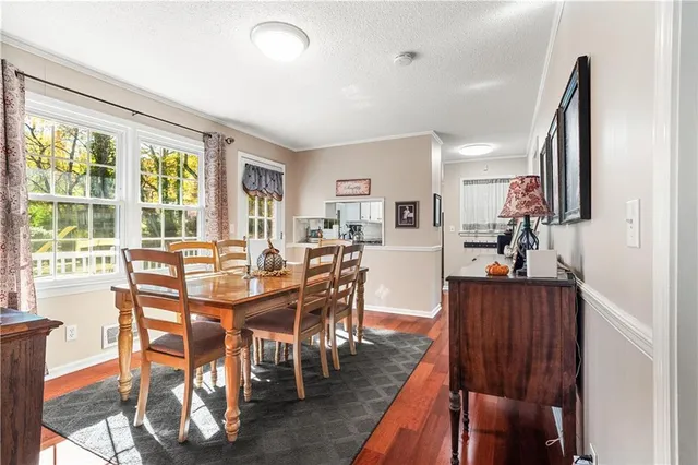 a view of a dining room with furniture window and wooden floor