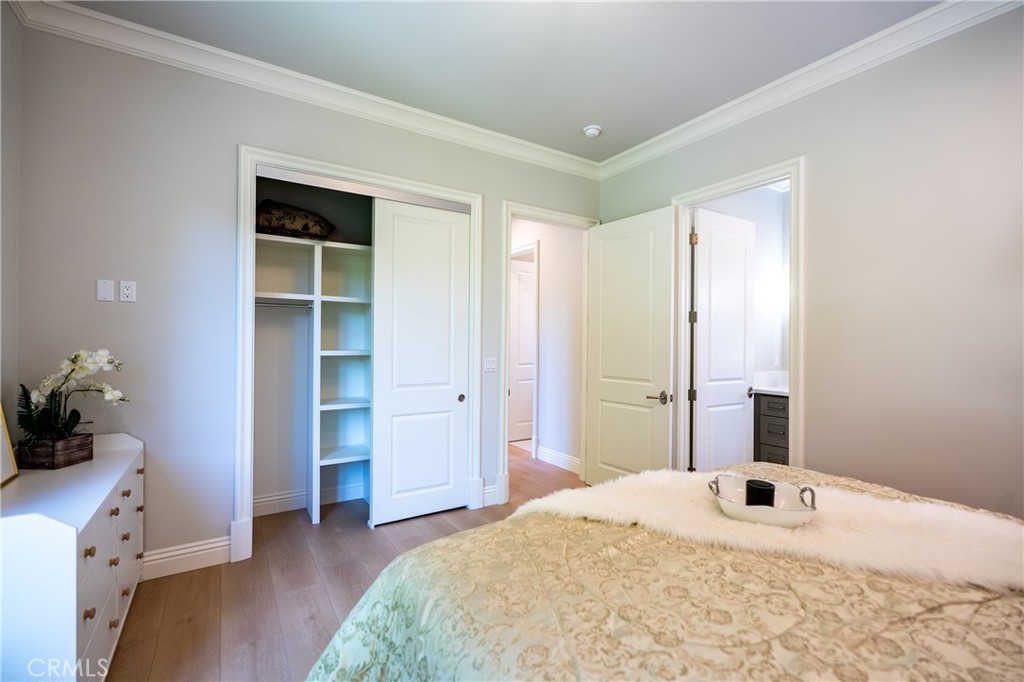 894 Fallen Leaf Road Arcadia, CA 91006 - Photo 19 of 28 a bedroom with a bed and a chandelier