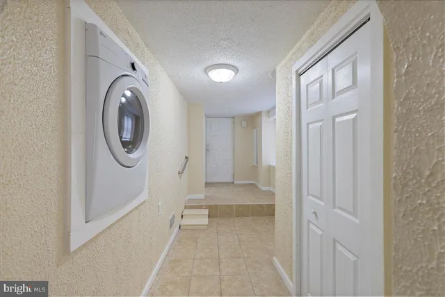a view of a hallway with washer and dryer