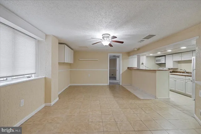 a view of a kitchen with a sink cabinets and a window