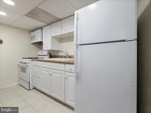 a kitchen with stainless steel appliances a refrigerator sink and cabinets