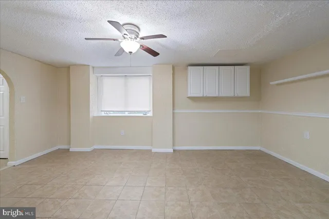 an empty room with closet and windows