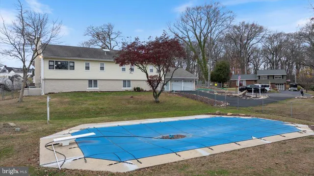a view of a house with backyard and a tree