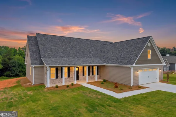 a front view of a house with a yard