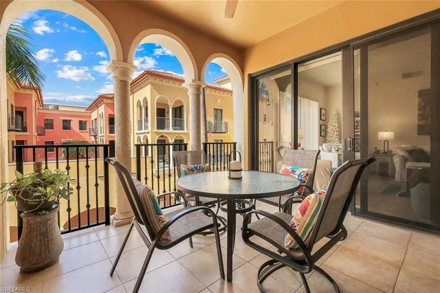 a view of a balcony dining area with furniture