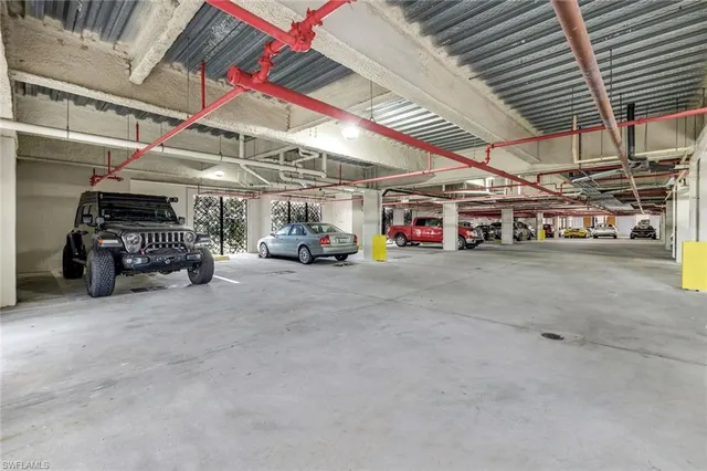 a view of parking garage with cars