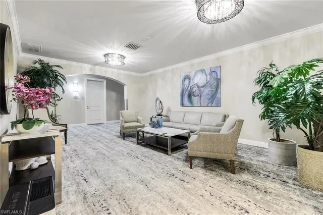 a living room with furniture and flowers